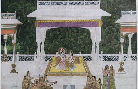 Radha and Krishna seated small at the centre of a white marble pavilion, attendants and musicians below, a dark grove behind — Kishangarh school